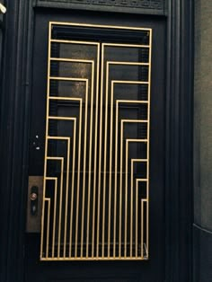 a black door with gold bars on it