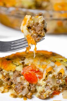 a slice of sausage and tomato quiche being lifted from a casserole dish