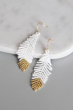 the white and gold beaded earrings