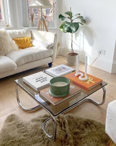 a living room filled with furniture and a glass coffee table