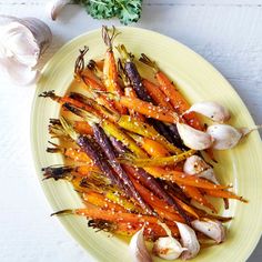 carrots, garlic and parsley on a yellow plate