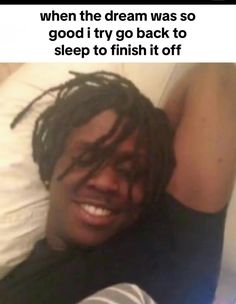 a man with dreadlocks laying in bed smiling at the camera and texting, when the dream was so good it try to finish it off