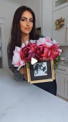 a woman holding flowers in front of her face with the caption'i love you mom '