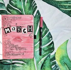 a notebook with the word march written on it next to a pen and some leaves