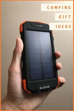 a person holding up a solar powered device with text overlay reading camping gift ideas