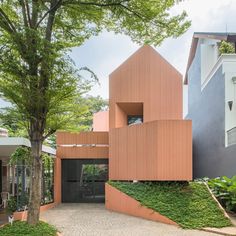 the house is made out of wood and has an unusual staircase leading up to it