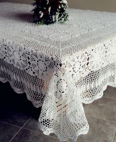 the table cloth is white and has flowers on it