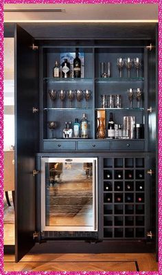 a wine cabinet with many bottles and glasses on it