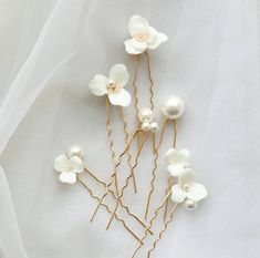 These luxurious Paloma Bridal Hair Pins are simple, elegant, and understated. Perfect for elevating any ethereal wedding day ensemble, each set of 6 includes bridal hair pins that feature a combination of faux pearls and delicate porcelain white floral motifs - Add them to any wedding day updo to create an unforgettable hair-do that will allow your natural beauty to take center stage. Incredibly versatile, they'll look just as chic when paired with a classy simple wedding dress as they do with a Hair Pins Bridal, Floral Wedding Hair, Bridal Hair Pin, Flower Hair Pins, Handmade Wedding Gifts, Silver Hair Pin, Gold Hair Pin, Bridesmaid Hair Accessories, Pearl Jewelry Wedding