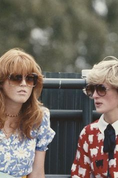 two women sitting next to each other on a bench