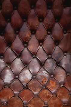 the back side of a brown leather chair