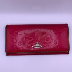 Long Wallet With Vivienne Westwood Signature Design. Embossed With Orb Logo And Hearts. Beautiful Pink With Brown Trim. Wallet Is Preloved With Signs Of Wear. No Major Callouts. See Photos Please And Ask Questions. Real Leather. Made In Italy. *Pet And Smoke Free Home* Vivienne Westwood Wallet, Vivienne Westwood Bags, Snap Wallet, Brown Trim, Signature Design, Pink Brown, Long Wallet, Vivienne Westwood, Real Leather