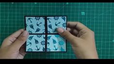 someone is making an origami card with blue and white designs on it's sides