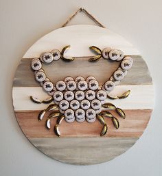 a crab made out of buttons is hanging on the wall