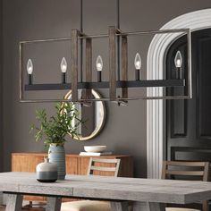 a dining room table and chairs with a potted plant on the table in front of it