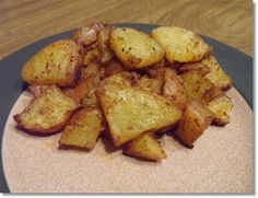 a plate full of cooked potatoes on a wooden table