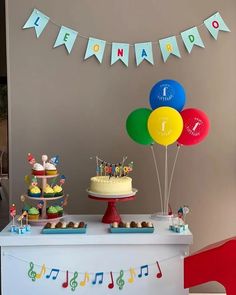 a birthday cake and cupcakes on a table