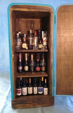 an old wooden cabinet filled with wine bottles