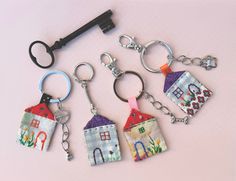 four house shaped keychains with keys attached to them