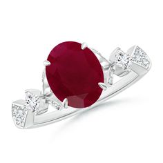 an oval ruby and diamond ring with three diamonds on the band, set in white gold