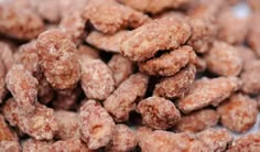 a pile of sugared donuts sitting on top of a table