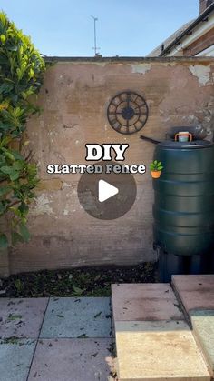 a large barrel sitting in front of a wall with the words diy started fence on it