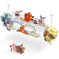 an assortment of hair accessories on display in front of a white background with flowers and pearls