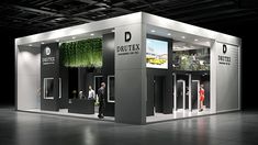 an exhibition booth with people standing in the doorways and green plants growing on the walls