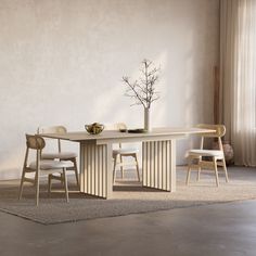 a dining table with chairs and a vase on it in front of a white wall