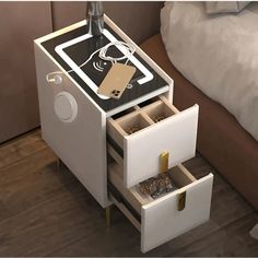 a night stand with two drawers and an electronic device on the bottom shelf next to a bed