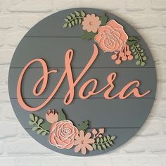 there is a sign with flowers on it that says oleeroa in pink and green