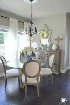 a dining room table with chairs and a chandelier