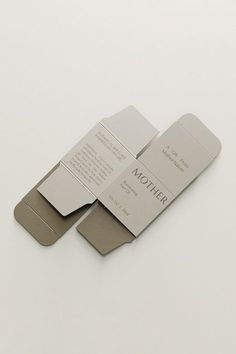 two folded business cards sitting on top of each other