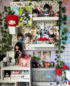 there are many toys on the shelves in this room, including dolls and figurines