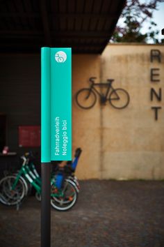 there is a sign that says bike rental in front of bikes parked outside the building