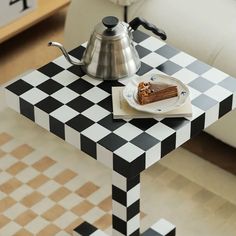 a piece of cake sitting on top of a black and white checkerboard table