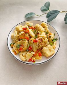 a white bowl filled with food on top of a table