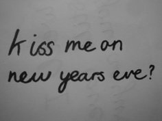 the words kiss me on new years eve written in black ink