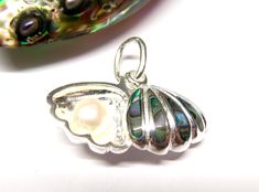 Silver Shell Pendant Motif "Shell with pearl" Abalone shell Freshwater cultured pearl one side a silver shell with abalone shell inserted the back a pearl in the silver shell both parts movable made of sterling silver good quality workmanship Height: 1.2cm Width: 1.3 cm Eyelet: 4 x 6 mm inner diameter Item number: AB - 5807 guaranteed 925 Sterling Silver Stamp 925 and BB as guarantee stamp our products are regularly tested by the Swiss Silver Control Shell With Pearl, Pendant Silver, Shell Pendant, Abalone Shell, Item Number, Jewelry Necklace Pendant, Shells, Handmade Items, Jewelry Necklaces