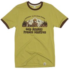 Need something to wear next time you're among friends? We've got you covered. This Smokey Bear t-shirt takes inspiration from vintage styles with a powerful message. Designed with campy colors and contrasting ribbing, it's a stylish way to support Smokey's Legacy. Your friends, whether they're people or woodland creatures, are sure to agree. Retro Outdoor Graphic Print T-shirt, Retro Graphic Print T-shirt For Outdoor, Retro Crew Neck T-shirt For Outdoor Activities, Vintage Screen Print T-shirt For Outdoor Activities, Vintage Screen Print T-shirt For Outdoor, Retro Cotton T-shirt For Outdoor Activities, Vintage Cotton T-shirt For Outdoor Activities, Retro Cotton Tops For Outdoor, Vintage Adventure Graphic T-shirt