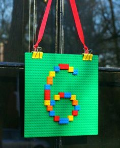 a bag made out of legos hanging from a window