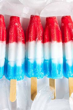 red, white and blue popsicles sitting on top of ice