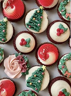 christmas cupcakes with frosting and decorations are arranged in a box on top of each other