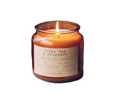 a candle that is sitting in front of a white background with the words green tea and bergamot on it