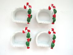 four pieces of white plastic with green and red decorations