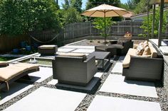 an outdoor seating area with chairs and umbrellas