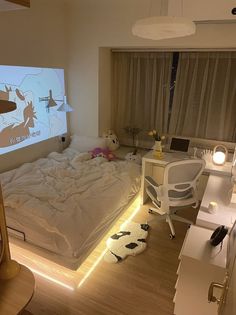 a bed room with a neatly made bed and a projector screen on the wall