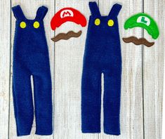 three blue overalls with hats and mustaches are on a white wooden background,