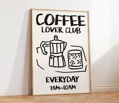 a coffee poster is on the wall next to a wooden floor and a white wall