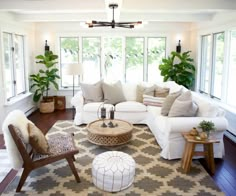 a living room filled with furniture and lots of windows